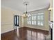 Formal dining room featuring hardwood floors, large windows, and a decorative ceiling at 11917 Chevis Ct, Charlotte, NC 28277