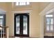 Grand foyer featuring ornate iron double doors and beautiful trim work at 11917 Chevis Ct, Charlotte, NC 28277