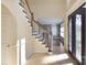 Welcoming foyer features tiled floors, a staircase with wood railing, and an elegant front door at 11917 Chevis Ct, Charlotte, NC 28277