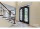 Grand foyer featuring staircase and ornate front door at 11917 Chevis Ct, Charlotte, NC 28277