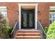 Ornate wrought iron front door with brick surround at 11917 Chevis Ct, Charlotte, NC 28277