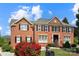 Stunning brick home with lush landscaping, manicured lawn and black shutters at 11917 Chevis Ct, Charlotte, NC 28277