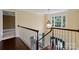 Upstairs hallway with hardwood floors, traditional chandelier, and a view of the staircase at 11917 Chevis Ct, Charlotte, NC 28277