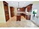 Gourmet kitchen boasts custom cabinets, tile backsplash, and a center island with gas cooktop at 11917 Chevis Ct, Charlotte, NC 28277