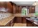 Close-up of kitchen featuring granite countertops, custom wood cabinets, and a tiled backsplash at 11917 Chevis Ct, Charlotte, NC 28277
