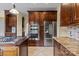Gourmet kitchen with stainless steel appliances, custom cabinets, and a center island cooktop at 11917 Chevis Ct, Charlotte, NC 28277