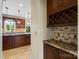 Well-lit kitchen with a breakfast bar, stainless appliances, and custom wood cabinets at 11917 Chevis Ct, Charlotte, NC 28277