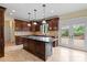 Well-equipped kitchen with center island, wooden cabinets, granite countertops, and modern appliances at 11917 Chevis Ct, Charlotte, NC 28277