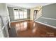 Cozy living room with fireplace, hardwood floors, and large bright window at 11917 Chevis Ct, Charlotte, NC 28277