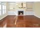 Inviting living room with a fireplace, built-in shelving, and hardwood floors at 11917 Chevis Ct, Charlotte, NC 28277