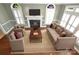 Spacious living room with a fireplace, hardwood floors, and lots of natural light at 11917 Chevis Ct, Charlotte, NC 28277