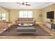Staged Living room with modern furniture and a ceiling fan at 11917 Chevis Ct, Charlotte, NC 28277