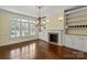 Inviting living room with large windows, built-in cabinets, fireplace and hardwood floors at 11917 Chevis Ct, Charlotte, NC 28277