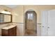 Elegant main bathroom with a vanity, decorative tile, a glass-enclosed shower, and an arched doorway at 11917 Chevis Ct, Charlotte, NC 28277