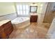 Main bathroom featuring a garden tub, a vanity, decorative tile, and a glass-enclosed shower at 11917 Chevis Ct, Charlotte, NC 28277