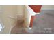 Carpeted staircase with white molding and rust colored accent wall, leading to upper or lower level at 11917 Chevis Ct, Charlotte, NC 28277