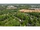 Beautiful aerial view of a home surrounded by lush greenery, near Huntersville Athletic Park, and new construction at 12328 Chickasaw Dr, Huntersville, NC 28078