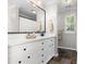 Stylish bathroom features white cabinets, granite countertops, black hardware, and tile floors at 12328 Chickasaw Dr, Huntersville, NC 28078