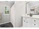 Clean bathroom with a shower and sink with black hardware and white finishes at 12328 Chickasaw Dr, Huntersville, NC 28078