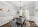 Beautiful dining room with wainscoting, elegant chandelier, and hardwood floors at 12328 Chickasaw Dr, Huntersville, NC 28078