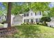 Traditional home featuring a well-kept lawn, mature trees, and classic architectural details at 12328 Chickasaw Dr, Huntersville, NC 28078