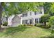 Charming two-story white home with black shutters, attached garage and manicured lawn and landscape at 12328 Chickasaw Dr, Huntersville, NC 28078