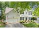 Traditional two-story home features manicured lawn, an attached garage, and an inviting driveway at 12328 Chickasaw Dr, Huntersville, NC 28078