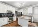 Bright kitchen featuring stainless steel appliances, an island with granite countertops, and white cabinets at 12328 Chickasaw Dr, Huntersville, NC 28078