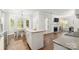 Bright kitchen island overlooking breakfast nook and living room with fireplace at 12328 Chickasaw Dr, Huntersville, NC 28078