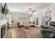 Comfortable living room with brick fireplace, hardwood floors, and ample natural light at 12328 Chickasaw Dr, Huntersville, NC 28078