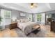 Spacious main bedroom with a tray ceiling, neutral colors, and a cozy sitting area at 12328 Chickasaw Dr, Huntersville, NC 28078