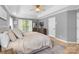 Comfortable main bedroom featuring natural light, neutral decor, and wood floors at 12328 Chickasaw Dr, Huntersville, NC 28078