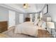 Inviting main bedroom with tray ceiling, barn door, and neutral color scheme at 12328 Chickasaw Dr, Huntersville, NC 28078
