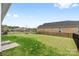 Large backyard with verdant lawn, secure fencing, and clear views of the surrounding neighborhood at 12705 Twilight Dr, Mint Hill, NC 28227