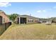 Spacious backyard with lush green grass, black fence, and views of neighboring homes at 12705 Twilight Dr, Mint Hill, NC 28227