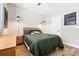 Modern bedroom with a queen-size bed, wooden accents, hardwood floors, and stylish lighting fixtures at 12705 Twilight Dr, Mint Hill, NC 28227
