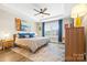Cozy bedroom featuring a ceiling fan, tray ceiling, large window and comfortable furnishings at 12705 Twilight Dr, Mint Hill, NC 28227