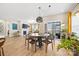 Bright dining area featuring modern lighting and views of the living room and outdoor patio at 12705 Twilight Dr, Mint Hill, NC 28227