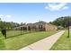Beautiful brick exterior home with black metal fencing and manicured lawn at 12705 Twilight Dr, Mint Hill, NC 28227