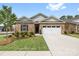 Inviting brick home featuring a well-manicured lawn, an attached two-car garage, and lovely landscaping at 12705 Twilight Dr, Mint Hill, NC 28227