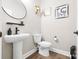 Modern half bathroom with pedestal sink, sleek fixtures, and contemporary décor at 12705 Twilight Dr, Mint Hill, NC 28227