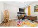Home office with multiple monitors, modern desk, and colorful rug, perfect for productivity at 12705 Twilight Dr, Mint Hill, NC 28227