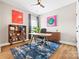 Bright home office with modern décor, stylish desk, and built-in shelving and cabinets for ample storage at 12705 Twilight Dr, Mint Hill, NC 28227
