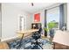 Well-lit home office with modern desk, chair, colorful rug, and large window providing natural light at 12705 Twilight Dr, Mint Hill, NC 28227
