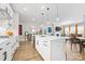 White kitchen island with stainless steel appliances, pendant lighting and open concept living at 12705 Twilight Dr, Mint Hill, NC 28227