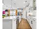 Bright, modern kitchen features stainless appliances, white cabinetry, an island, and hardwood floors at 12705 Twilight Dr, Mint Hill, NC 28227