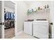 Laundry room with a full-size washer and dryer, storage shelves, and access to the closet at 12705 Twilight Dr, Mint Hill, NC 28227