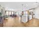 Spacious open-concept with hardwood floors, modern lighting, kitchen island, and comfortable seating at 12705 Twilight Dr, Mint Hill, NC 28227