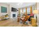 Bright living room with hardwood floors, fireplace, large windows, modern furniture, and a colorful rug at 12705 Twilight Dr, Mint Hill, NC 28227