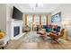 Open-concept living room features a fireplace, hardwood floors, modern furniture, and stylish decor at 12705 Twilight Dr, Mint Hill, NC 28227